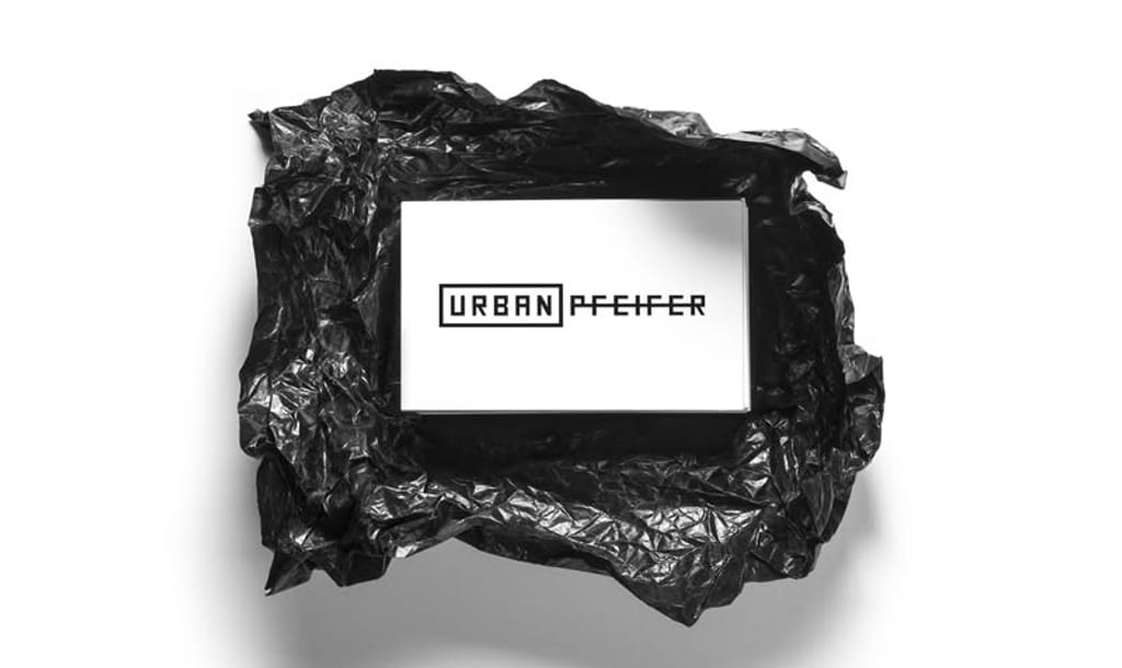 Branding: Urban Pfeifer business cards nested in crumpled black wrap